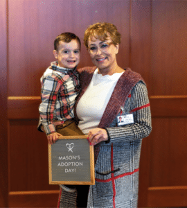 Lone Star CASA Volunteer Dianne carrying her CASA Kid Mason on his adoption day at court